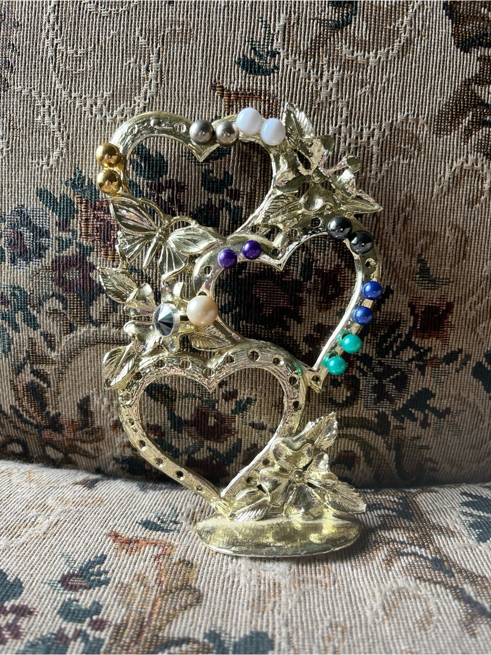 Gold Heart-Shaped Decorative Jewelry Holder with Colorful Earrings.
